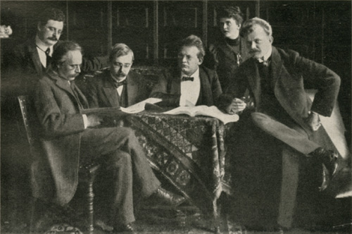 Max and with (from left to right) Theodor Müller-Reuter, Max Hehemann, and in Essen 1905 sitting over the score of the , . – Shown in , fig. 54.